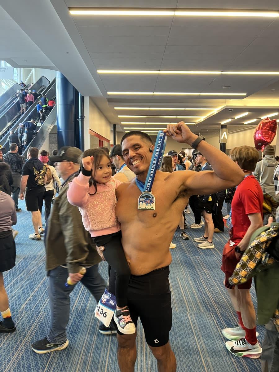 Victor Sauceda after a race, finisher medal around his neck